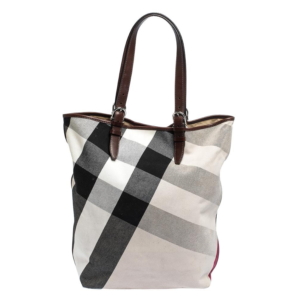 Burberry has exclusively crafted this graceful tote for the fashionista in you. It is crafted from Mega Nova check canvas and enhanced with leather. The beige & brown bag's interior is lined with canvas and is sized to hold all your essentials. The