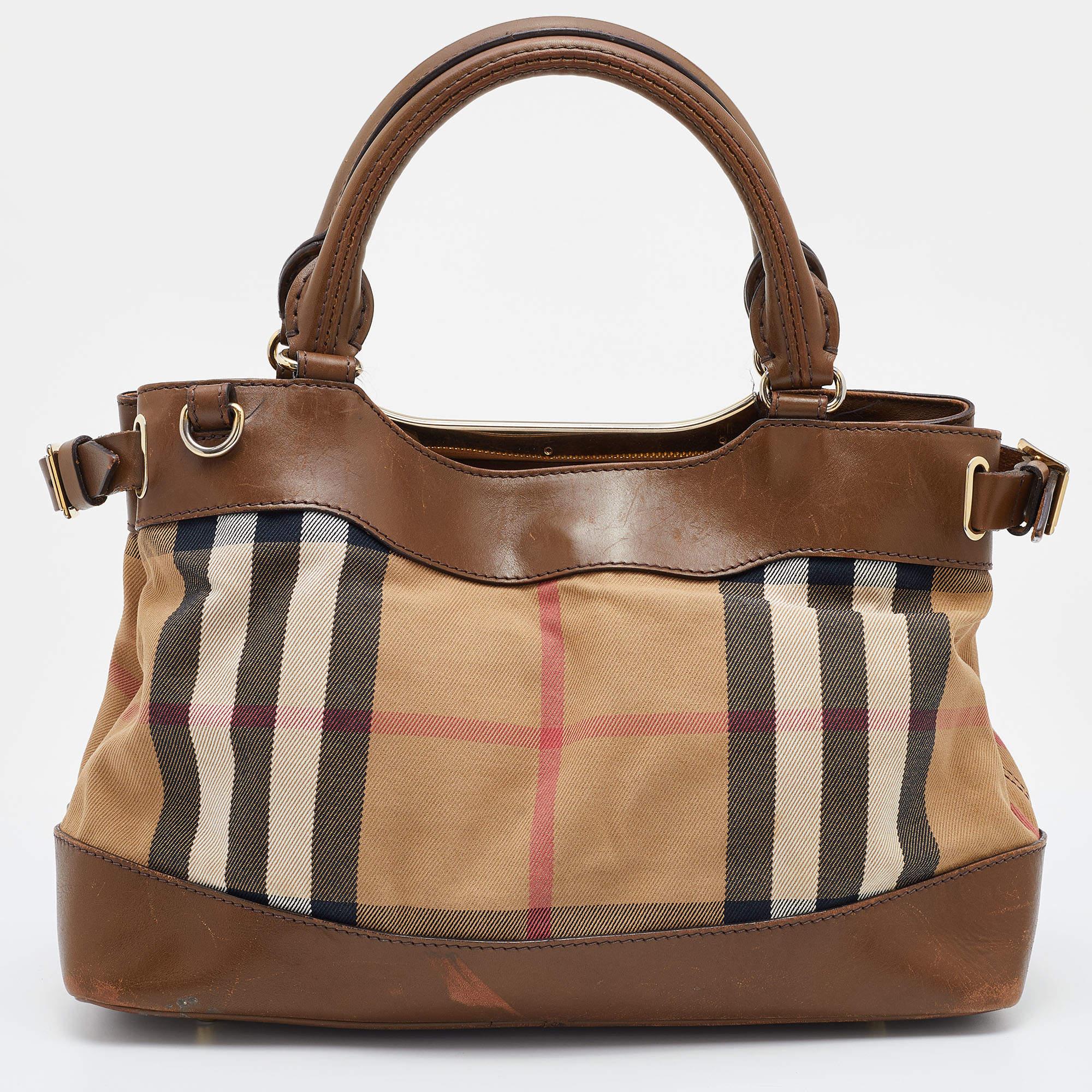 Expertly crafted and skillfully designed, this Burberry creation is a must-have in every bag collection. It is made from a mix of Nova check canvas and leather. Features like a shoulder strap, top handles, and spacious interior make it a practical