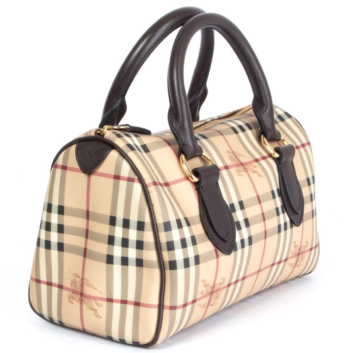 100% authentic Burberry Haymarket Medium bowling bag in beige, red, black and white coated canvas featuring brown leather handles and gold-tone trimming. Lined in brown canvas with one open pocket against the back. Has been worn and is in excellent
