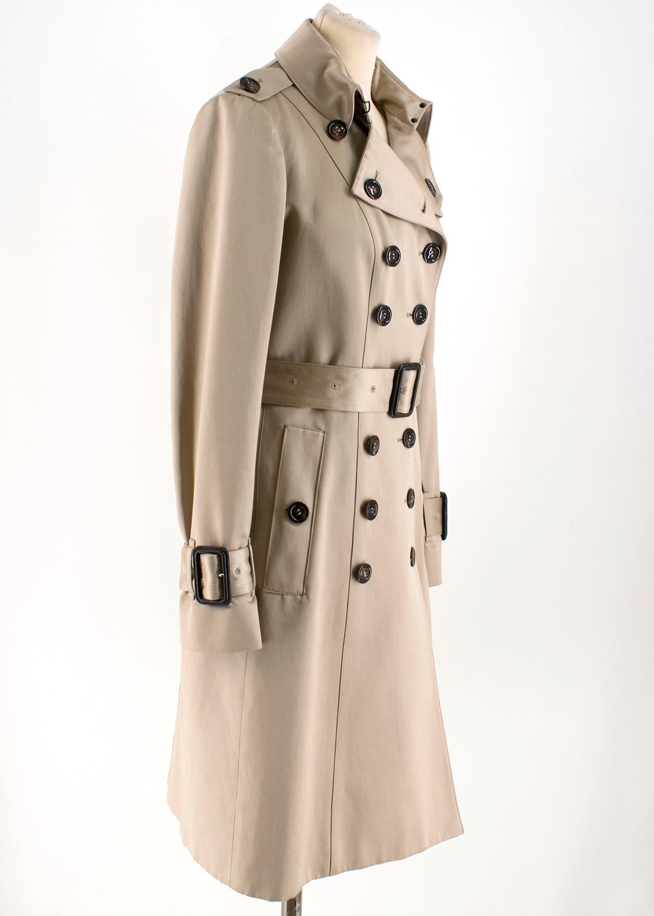 Burberry Beige Trench Coat 

- Classic Beige Trench Coat
- Woven Cotton Sateen 
- Softly tailored slim fit cut
- Double-breasted
- Dark horn buttons down center front 
- Point lapel
- Belted cuffs, belted waist
- 100% Cotton

Please note, these