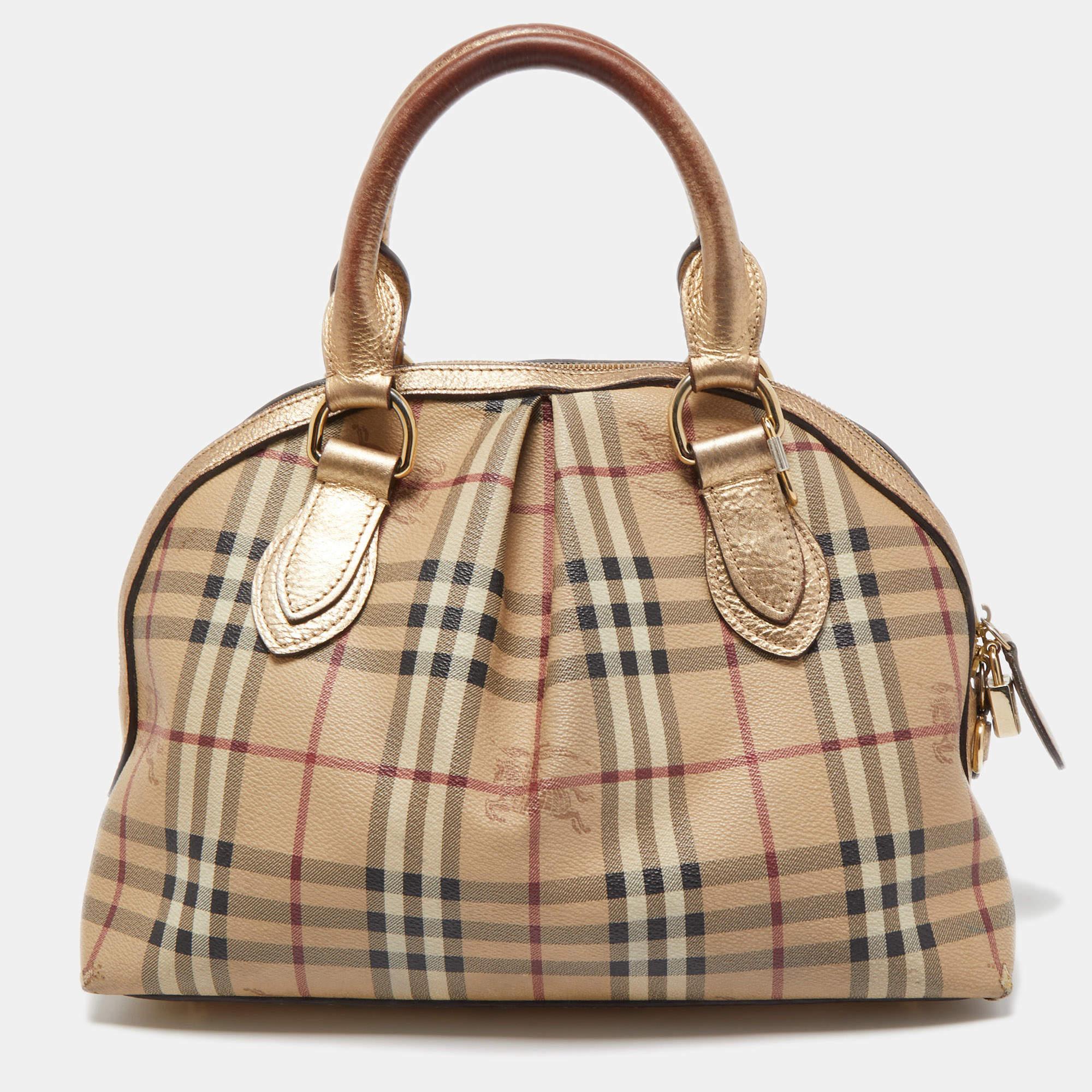 Burberry's Thornley satchel is for everyday use. It has been crafted from signature Haymarket Check PVC, leather trims and gold-tone hardware. It comes with dual-rolled handles and the zip-top closure opens to a well-sized canvas interior.

