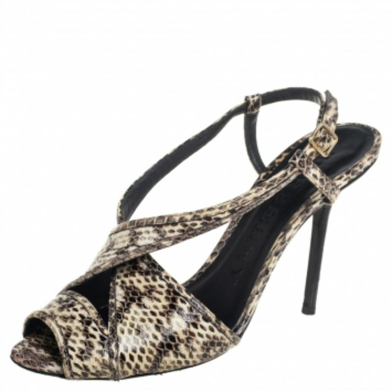 These gorgeous Burberry sandals exude style and bespoke charm. Crafted in python-embossed leather, they come with criss-cross straps at the vamps. Elevated with 10 CM heels, they are equipped with slingback straps with gold-tone buckles. The insoles