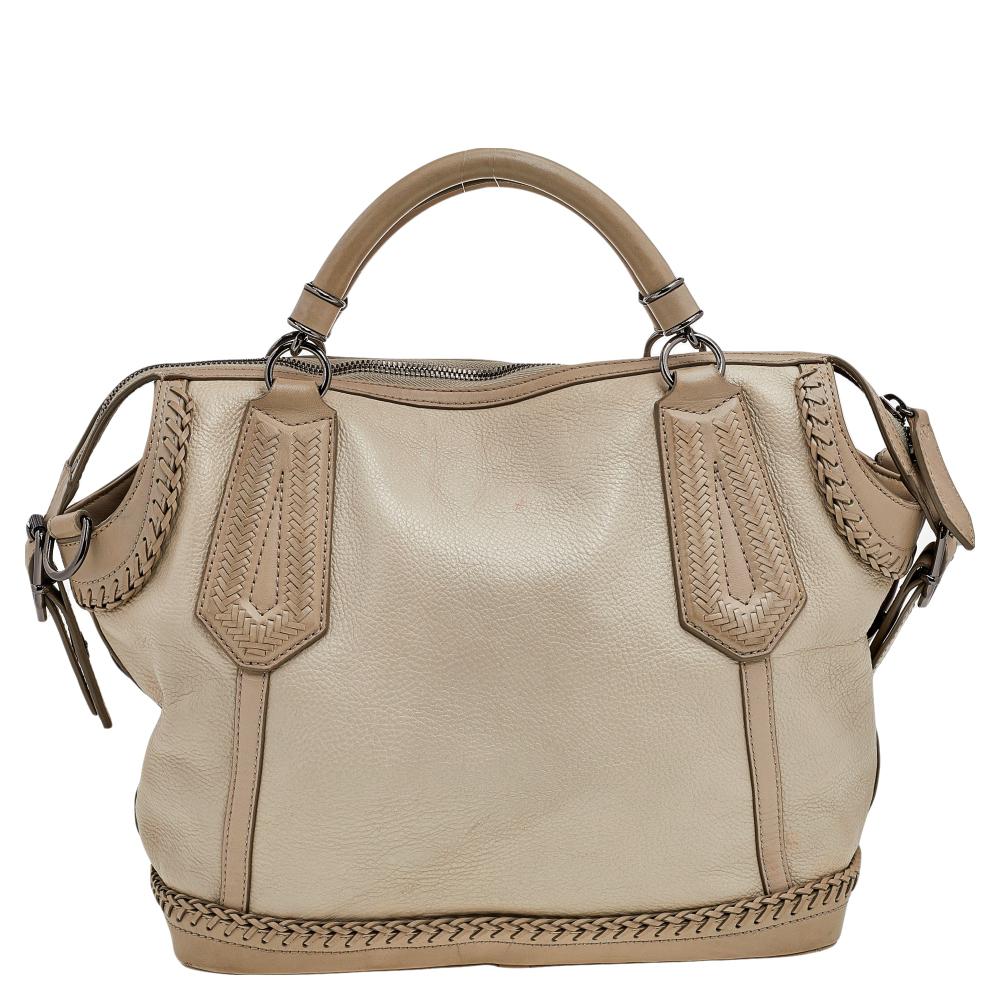 This Burberry satchel brings such a fine look that you're sure to look fashionable whenever you carry it. Ideal to use as a travel bag, it comes crafted from leather and is designed with two handles, a shoulder strap, and a spacious