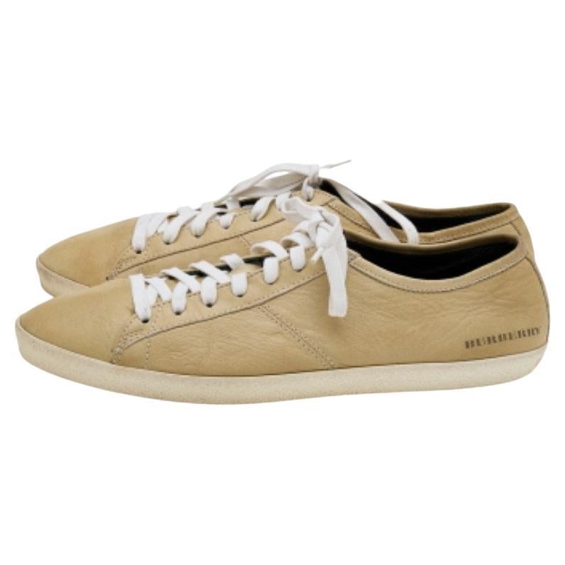 Coming in a classic low-top silhouette, these Burberry sneakers are a seamless combination of luxury, comfort, and style. They are made from leather in a beige shade. These sneakers are designed with logo details, laced-up vamps, and comfortable