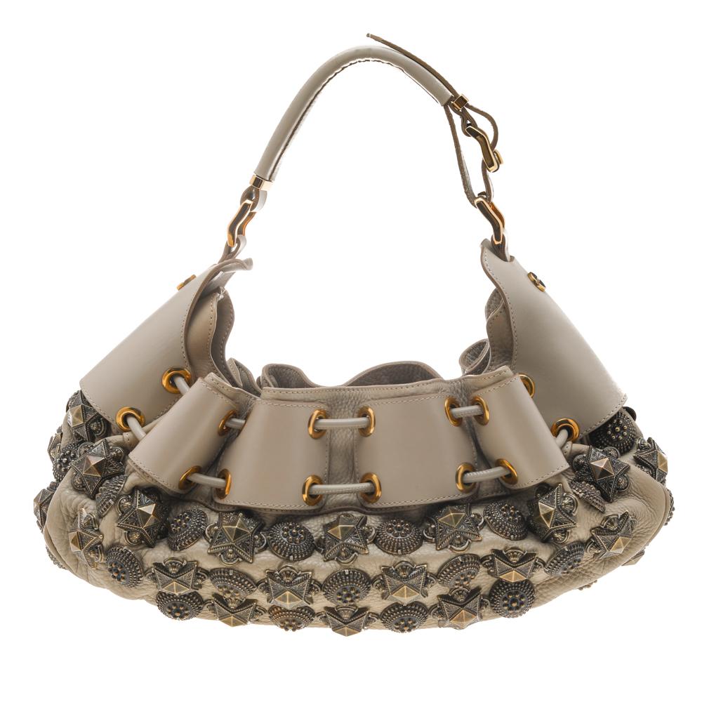 This Burberry Mason Warrior hobo will make a splendid addition to your bag collection. The hobo is crafted from leather, and it has studs, a single handle, drawstring detail, and a well-sized interior.

Includes: Original Dustbag, Info Card