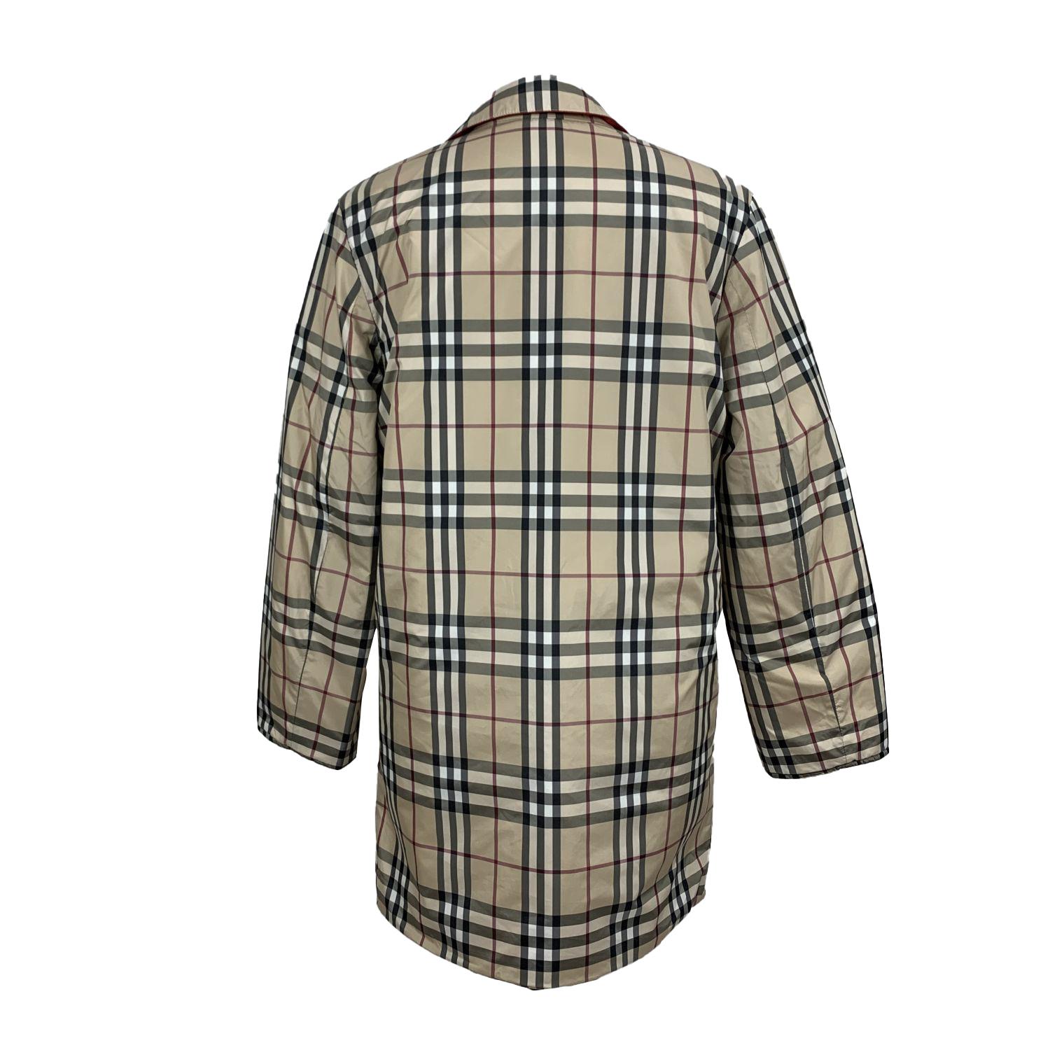 Beautiful Burberry reversible jacket. Composition: 99% Polyester, 1% Polyester. First side is in the iconic beige nova check pattern. The reversed side is red polyester. Lightly padded. Collared neckline. Front button closure. Slash pockets on the