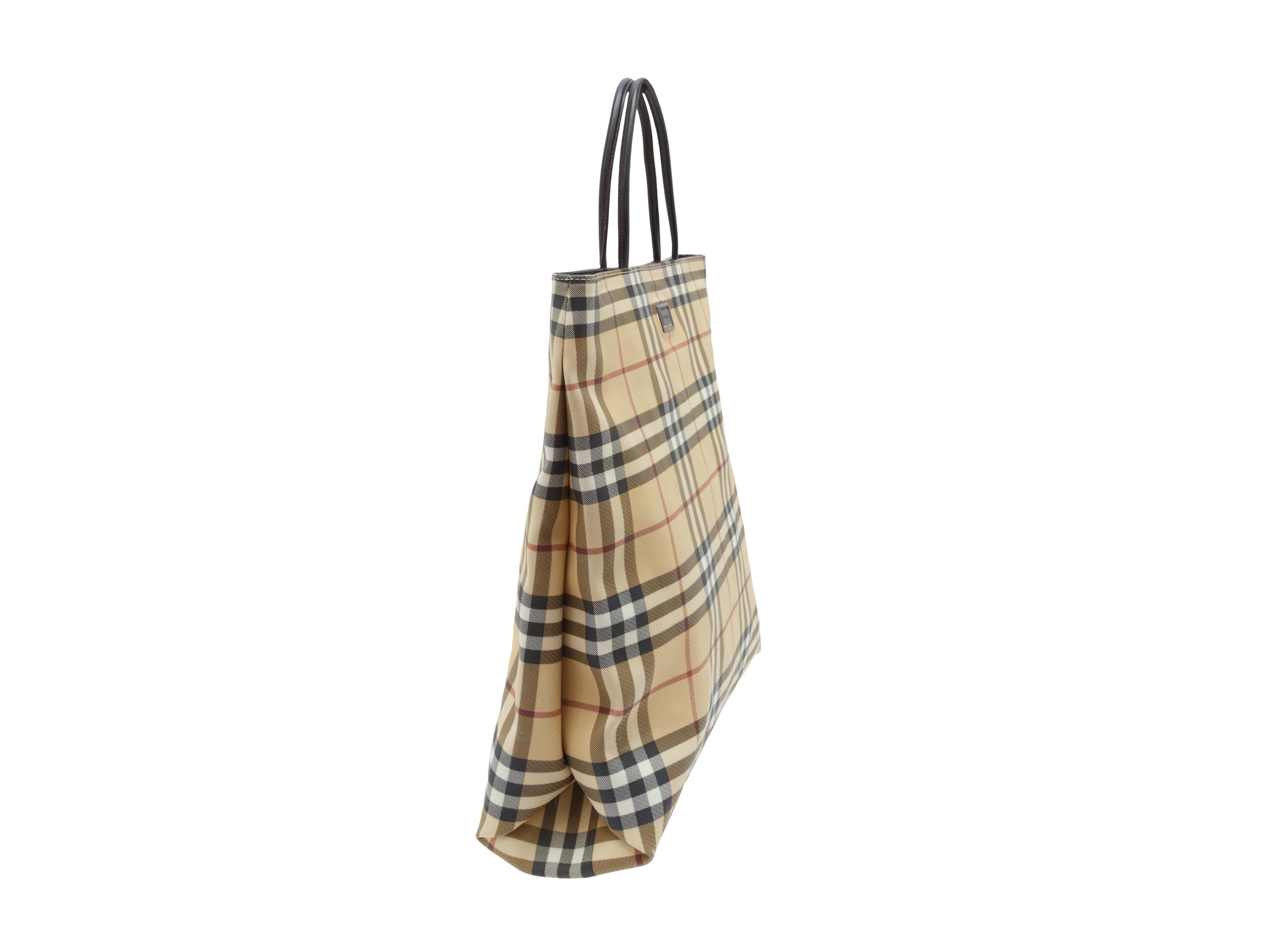 Product details: Beige Burberry Nova Check Tote Bag. The Burberry tote bag has a coated canvas body, leather handles, and it's lined inside. The bag has a magnetic snap closure. 13