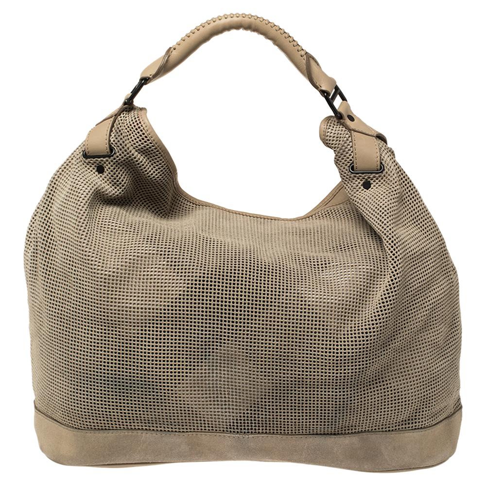 Simple and stylish, this bag is designed in a perforated suede body trimmed with leather. Lined with the fabric, this hobo offers both style and functionality. Look stylish and fancy in this Burberry accessory. Complement your attire by adorning