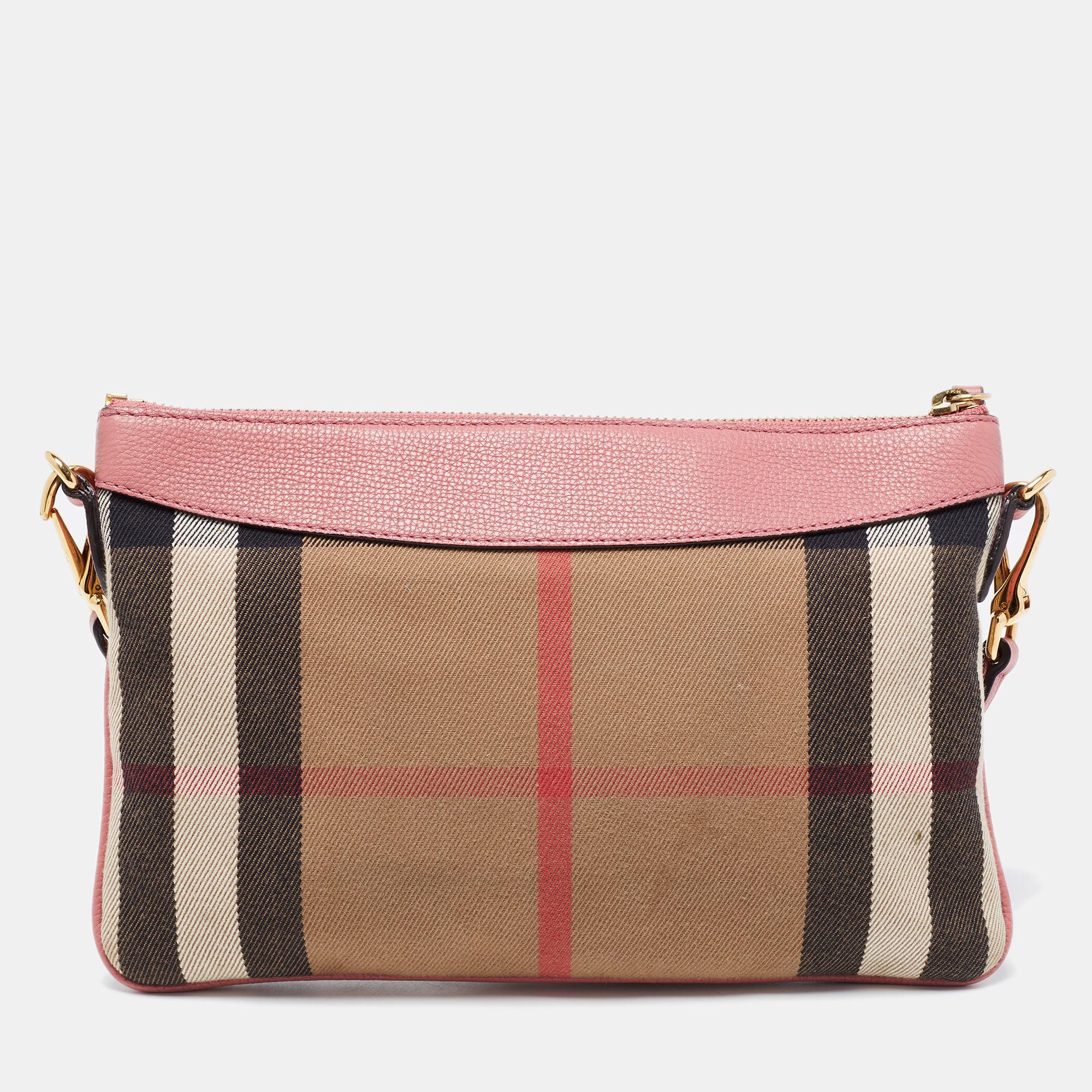 This cute crossbody bag comes from Burberry. It is crafted from House Check canvas and leather into a structured shape. The beige and pink bag has a zip closure, a smooth interior with several slots and is finished with gold-tone hardware.

