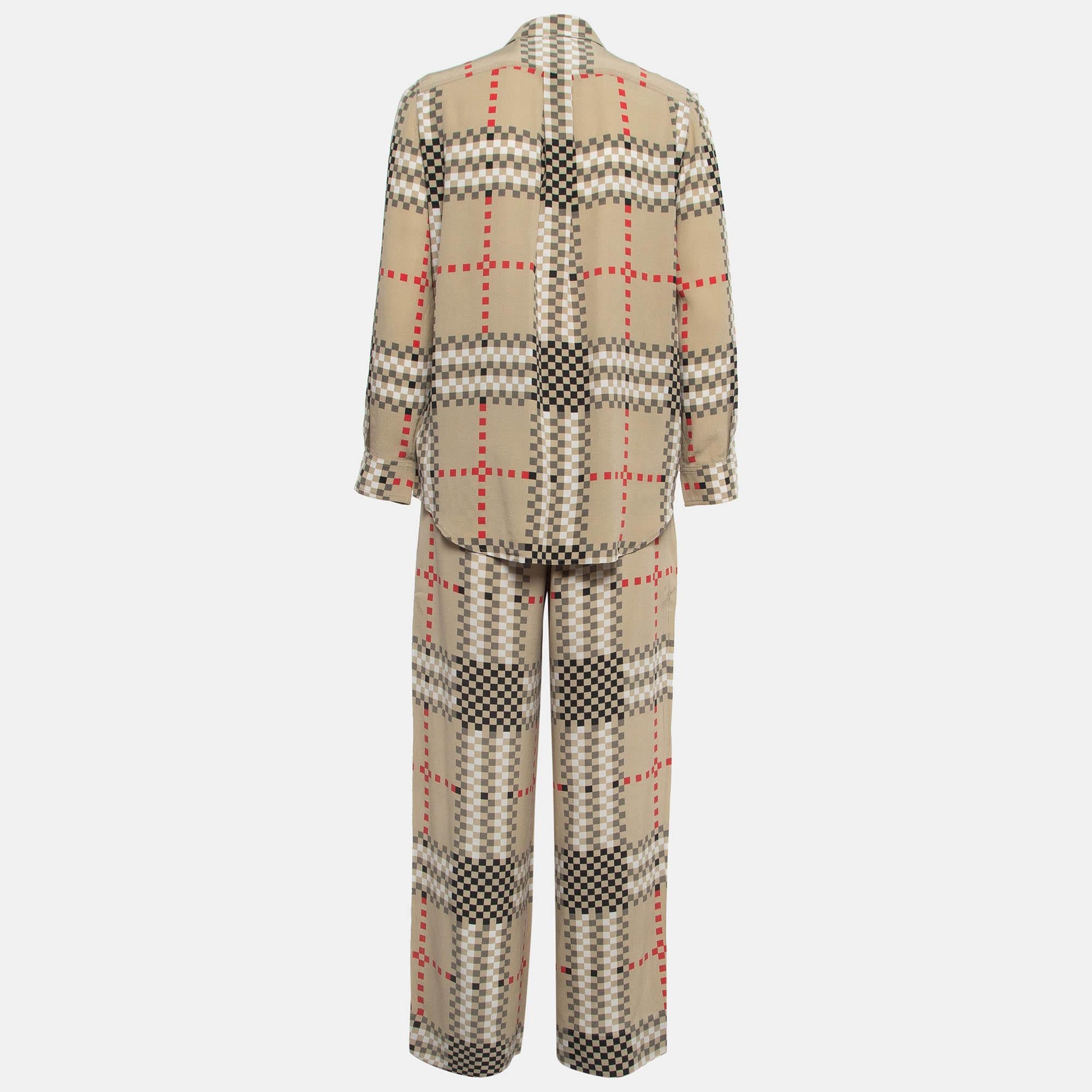 Crafted from sumptuous silk, the Burberry set exudes timeless charm. The shirt boasts a refined pixel check pattern, while the pants complement with a matching design. Effortlessly stylish, this ensemble epitomizes Burberry's signature aesthetic,