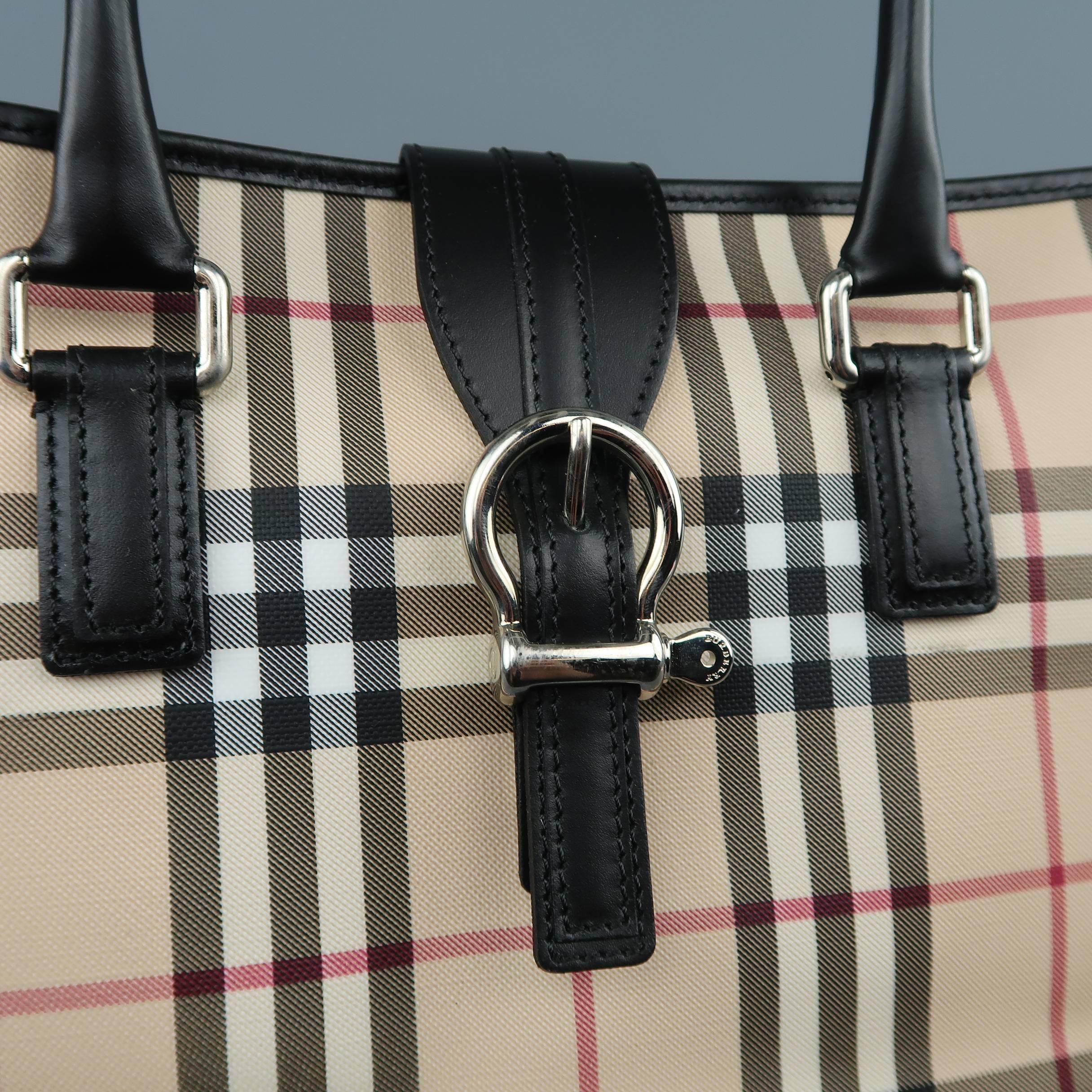 BURBERRY shoulder tote bag comes in beige signature plaid print rubberized canvas with black leather covered double top handles, snap belt buckle top closure, and expandable sides with snaps. Made in Italy.
 
New with Tags.
 
Measurements:
 
Length: