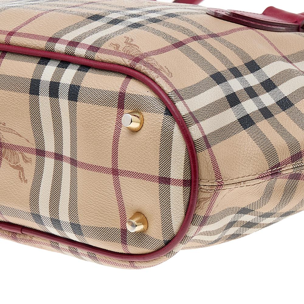 Fashioned with Haymarket Check canvas and leather on the exterior, this satchel will make a reliable addition to your closet. The everyday bag by Burberry is lined with fabric and held by dual handles and a shoulder strap.

