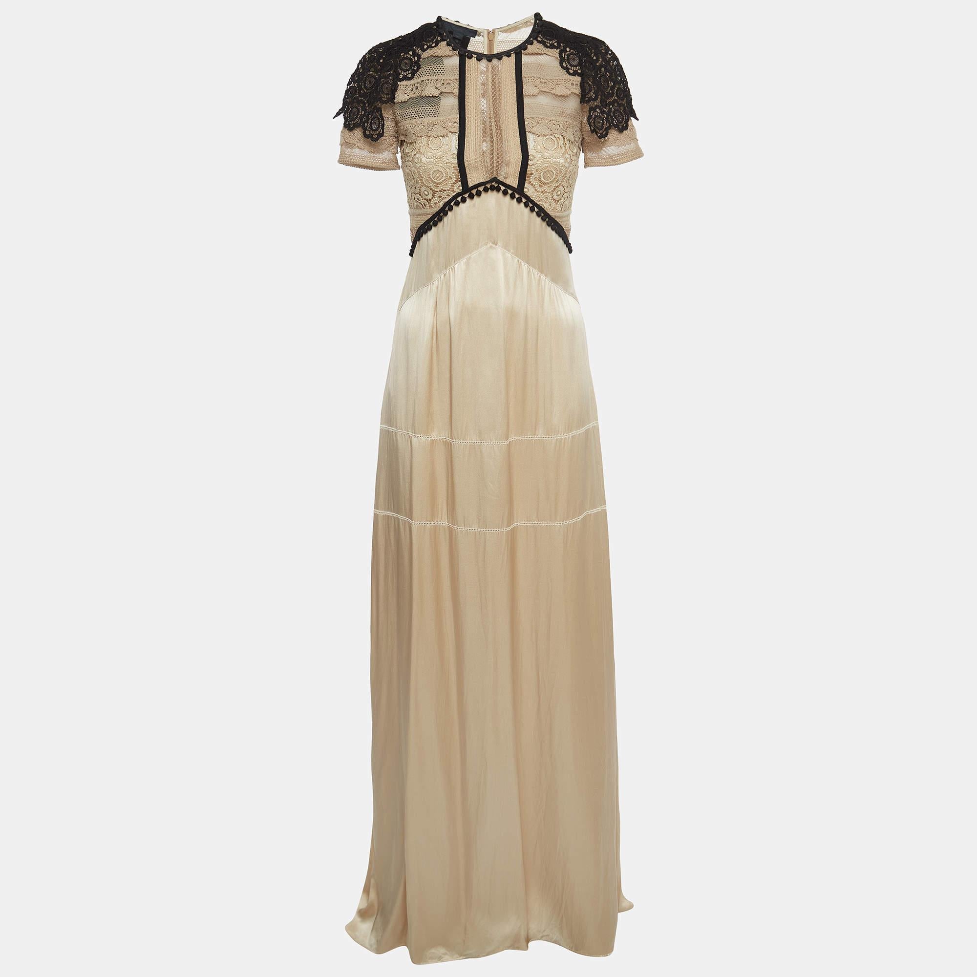 The Burberry dress exudes timeless elegance. Crafted from luxurious silk, its flowing silhouette and intricate lace detailing create a harmonious blend of sophistication and sensuality. The semi-sheer design adds a touch of allure, making it a