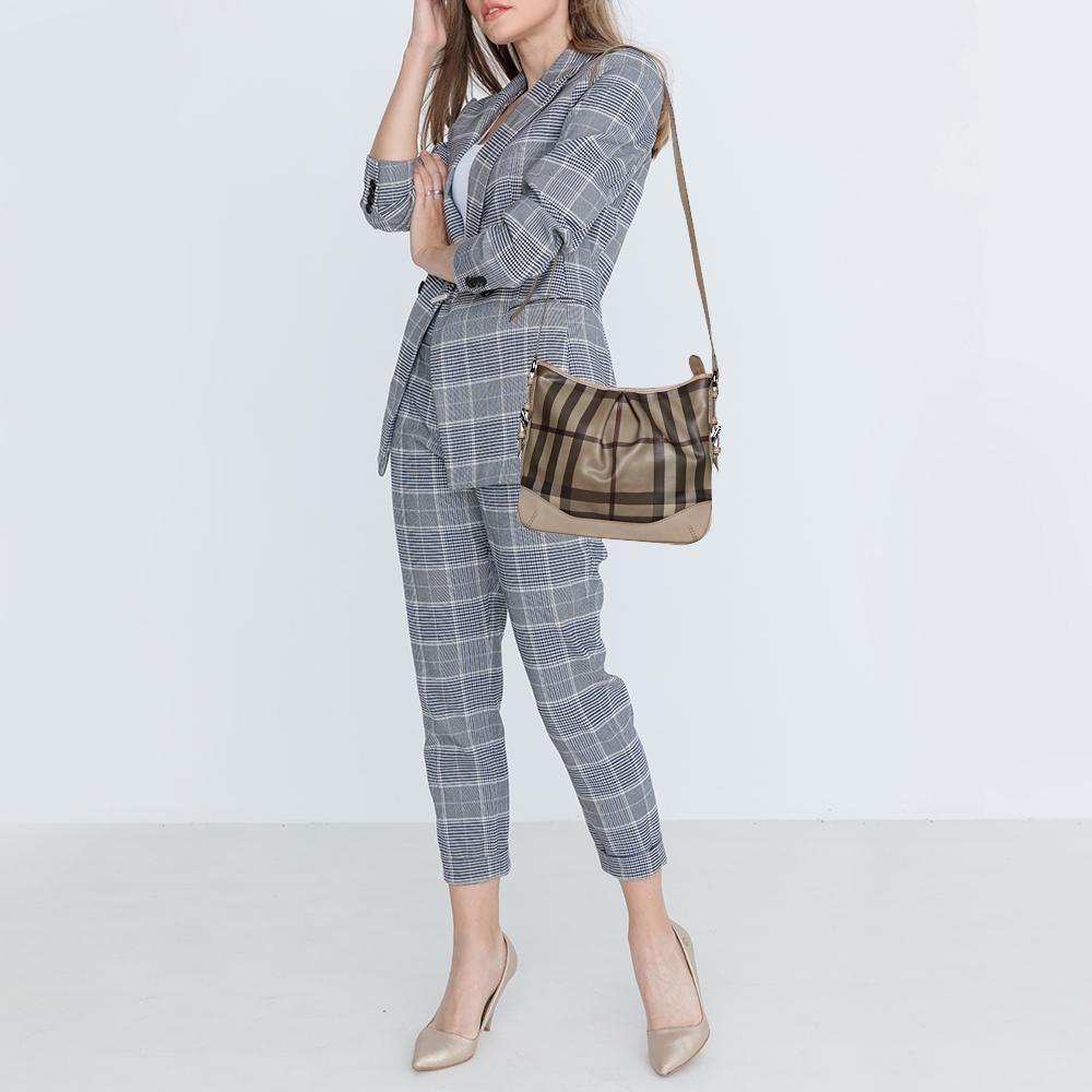 This adorable and classic crossbody bag features a signature smoke check coated PVC body with leather trims. Silver-tone hardware makes this bag luxurious and the interior offers just enough space for all of your daily essentials. This is the