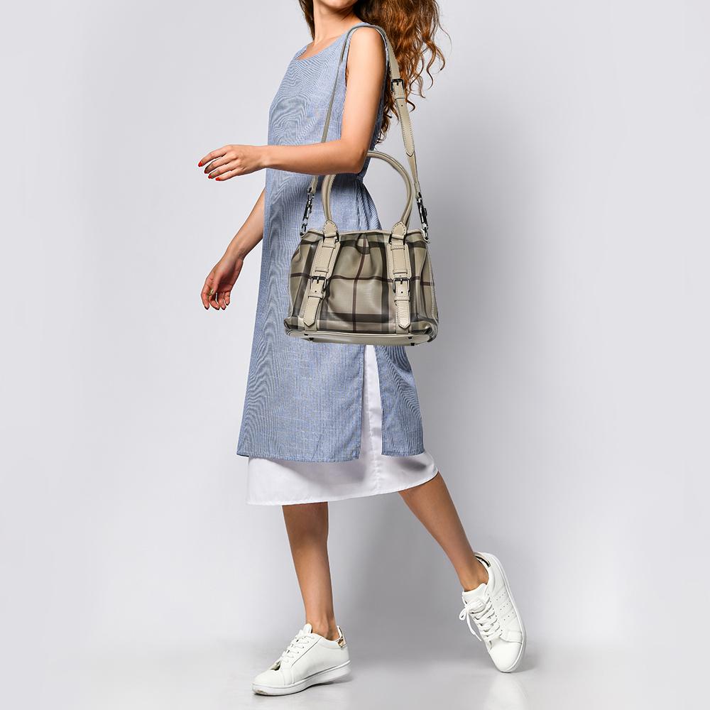 Spacious and captivating, this Northfield tote is from Burberry. It has been crafted from Smoked Check coated canvas. It is equipped with two rolled handles, a detachable shoulder strap, and a well-sized canvas interior. Lastly, the bag is complete