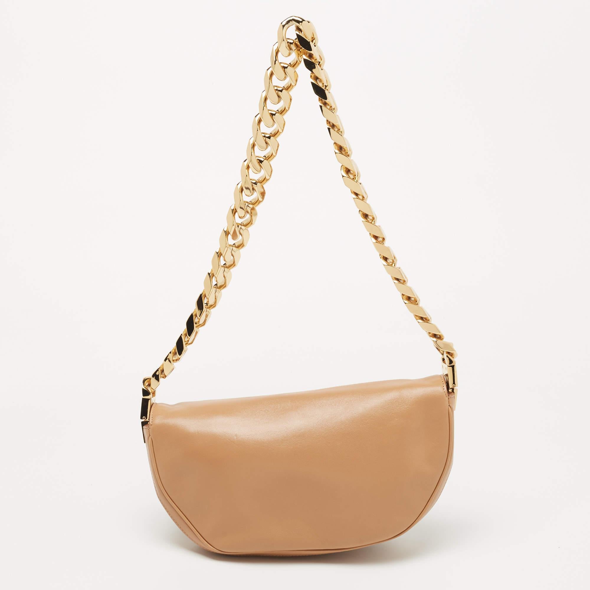 Structured, sophisticated, and stylish are some words that describe this shoulder bag! Crafted from best quality material, the creation is adorned with the label's signature appeal and equipped with a well-spaced interior. Carry it to parties or