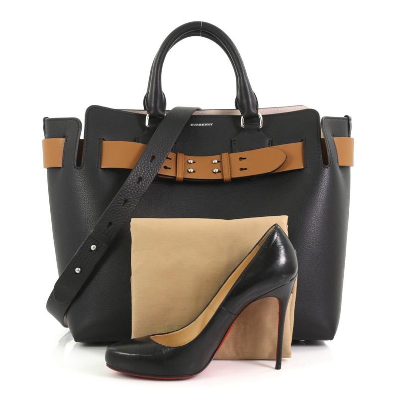 This Burberry Belt Tote Leather Medium, crafted in black leather, features dual rolled leather handles, wide belt at the top, and silver-tone hardware. It opens to a nude leather interior with slip pockets. **Note: Shoe photographed is used as a
