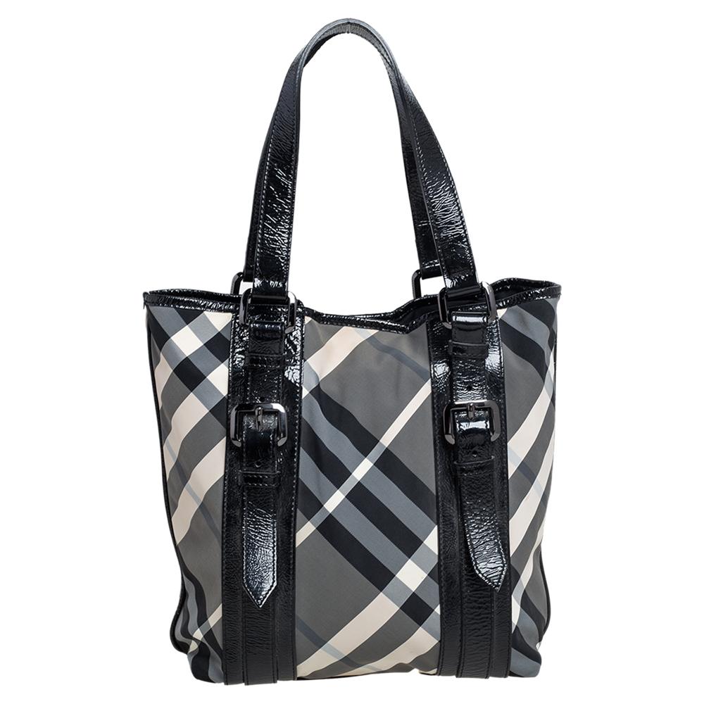 Complete a stylish look with this beautiful Burberry Lowry tote. It has the iconic Beat check-coated nylon & patent leather exterior and opens up to a spacious nylon interior with the brand label. This bag is completed with buckled straps on the