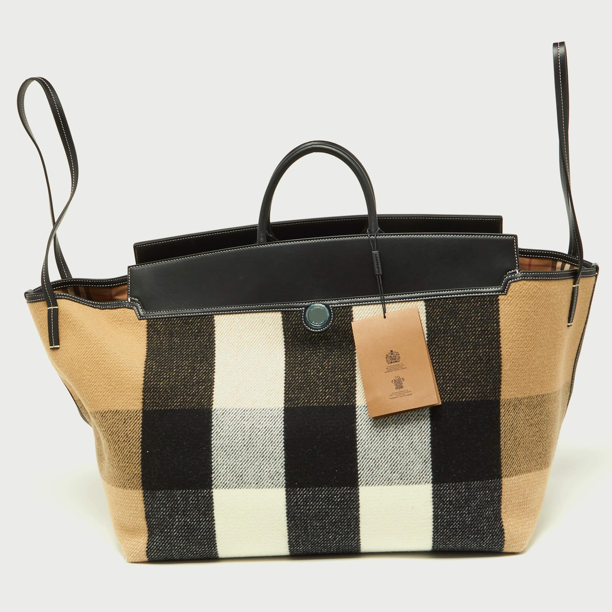 The Burberry Society Holdall Tote exudes timeless elegance. Crafted from high-quality wool and leather, its spacious interior accommodates essentials effortlessly. The iconic check pattern adds a sophisticated touch, making it a versatile and
