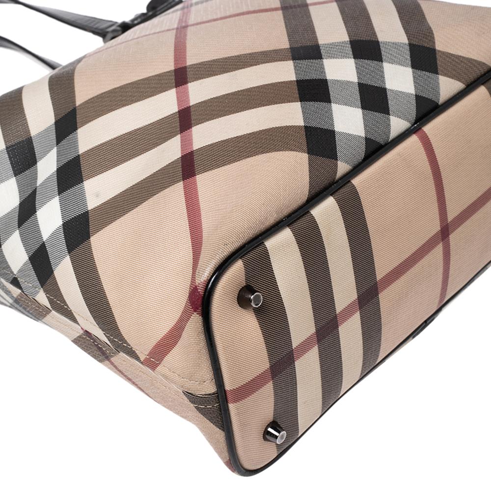 This beautifully stitched Supernova Check canvas and leather tote is by Burberry. With a capacious fabric-lined interior, it will house more than your essentials. Boasting two handles and a fine finish, this tote offers style and practical ease.


