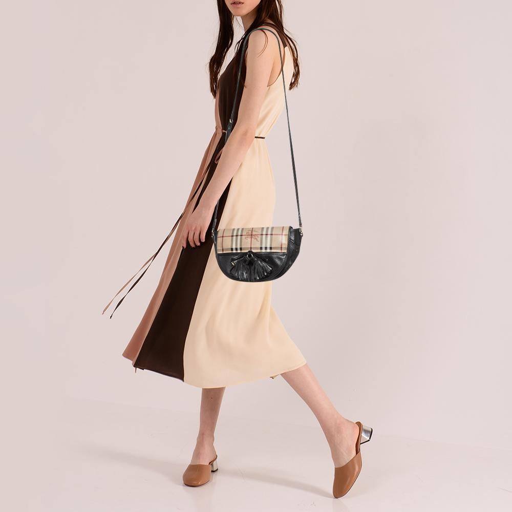 This Burberry Maydown crossbody is an ideal bag to carry throughout the year. It has been crafted in Italy and is made from fine leather and coated canvas. The exterior supports the brand's signature Haymarket check as well as a plain black surface