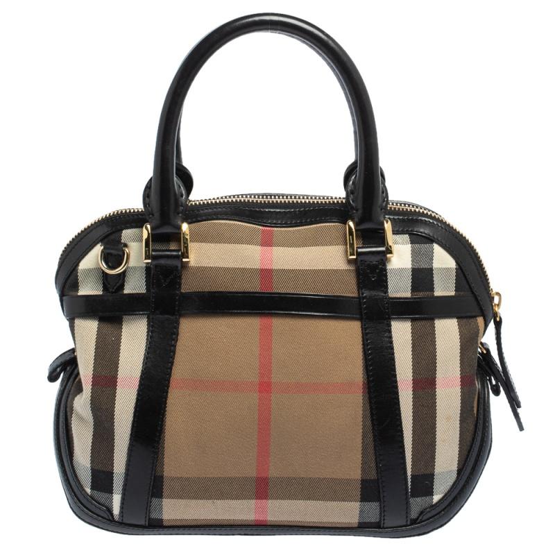 Spacious and captivating, this Orchard Bowling bag is from Burberry. It has been crafted from House Check fabric and leather and is equipped with a well-sized canvas interior, two rolled handles and a detachable shoulder strap. The bag is complete