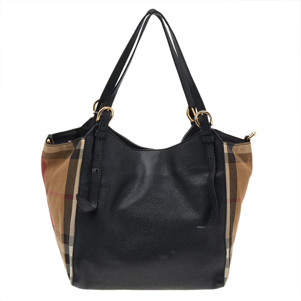 This Canterbury tote from Burberry is crafted their signature House Check canvas and leather. It comes with dual flat handles, protective metal feet, and a fabric-lined interior that can hold all your daily necessities. Simple in design, the bag is