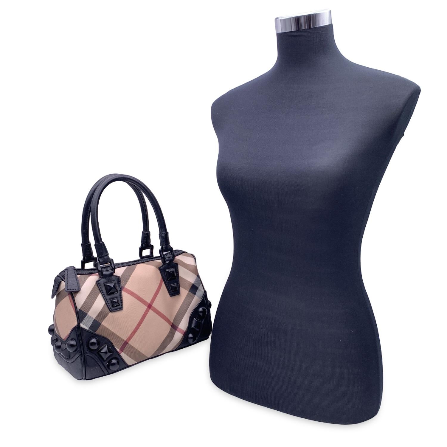 This beautiful Bag will come with a Certificate of Authenticity provided by Entrupy. The certificate will be provided at no further cost

Burberry 'Check on Studs' boston bag in beige Nova Check canvas and black leather trim and handles. Black studs