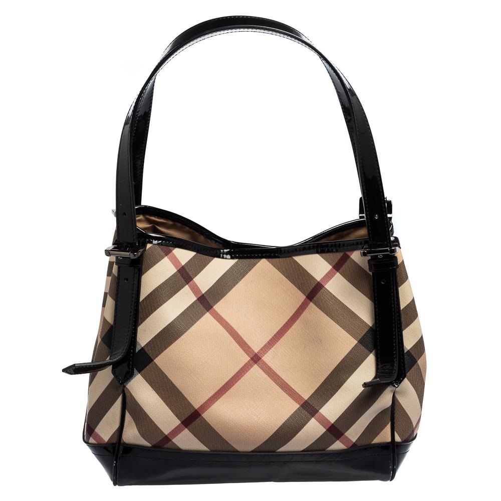 This Canterbury tote from Burberry is crafted from Nova check PVC and patent leather. It comes with dual flat handles, protective metal feet, and a spacious interior that can hold all your daily necessities. Simple in design, the bag is perfect for