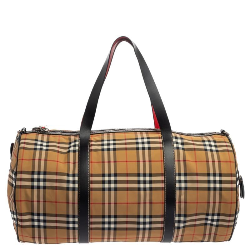 Burberry's Barrel bag is ideally sized to accompany you on your travels. It is crafted in Vintage Check nylon and leather, held by two handles, and equipped with a nylon interior. It is complete with a shoulder strap.

Includes: Shoulder Strap,
