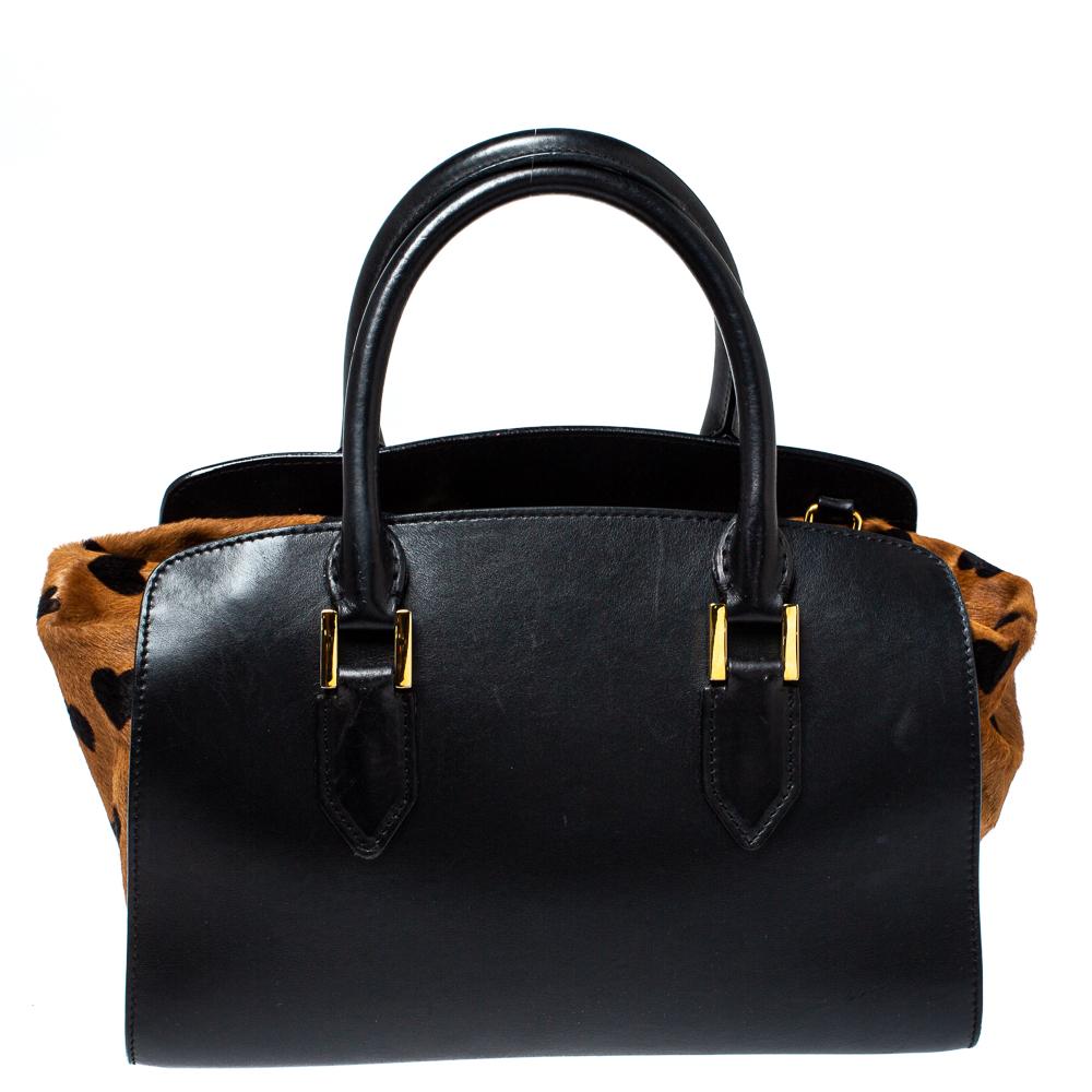 Carry the world with you and without missing out on style using this Burberry satchel. It is made from heart-printed calfhair as well as leather and equipped with two shapely handles, gold-tone hardware, and a canvas interior.

Includes: Original