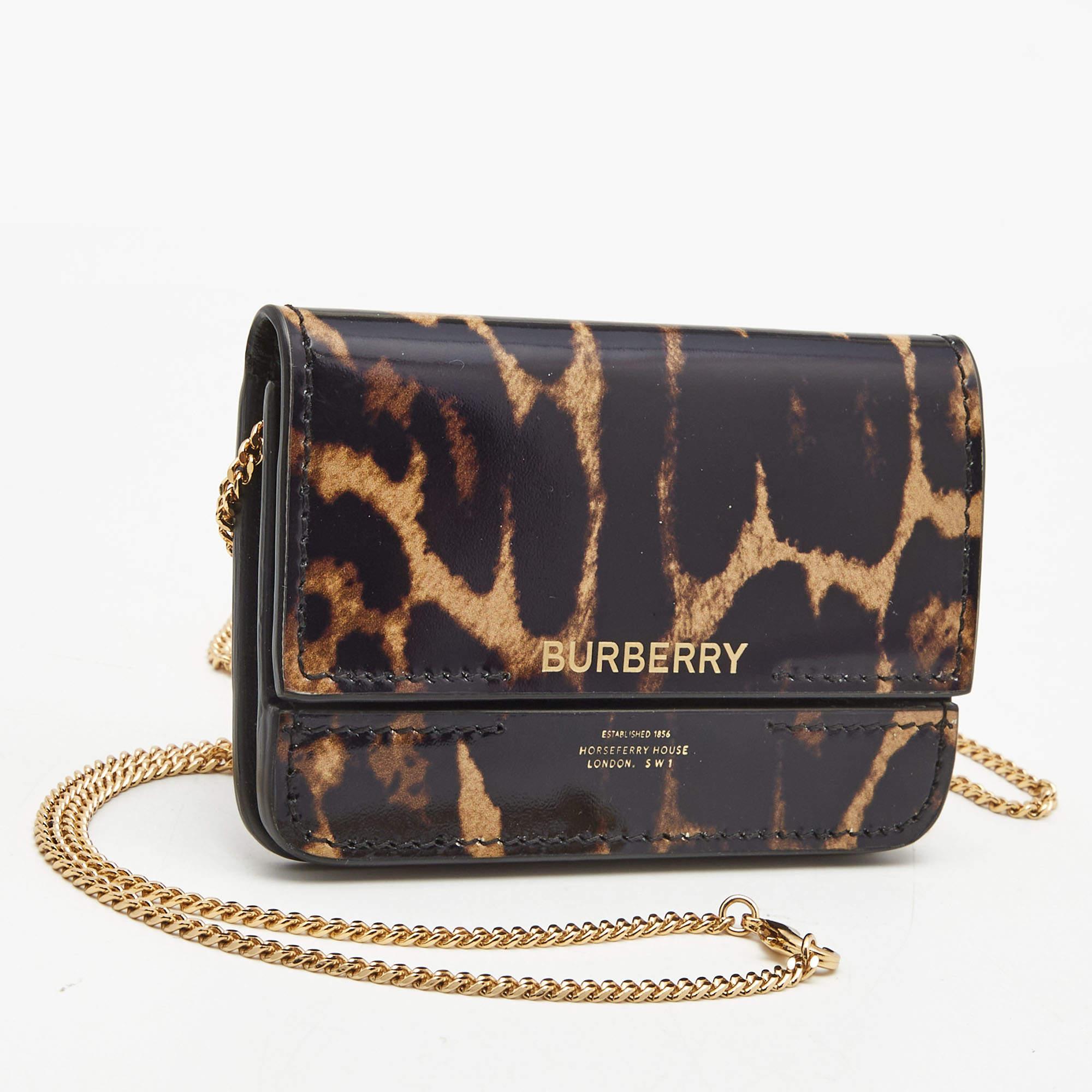 With a clean and classic structure, this Burberry card case is a must-have. It is created from leather with a striking animal print on the exterior and displays a brand signature on the front, a chain strap, and a lined interior.

Includes
Brand
