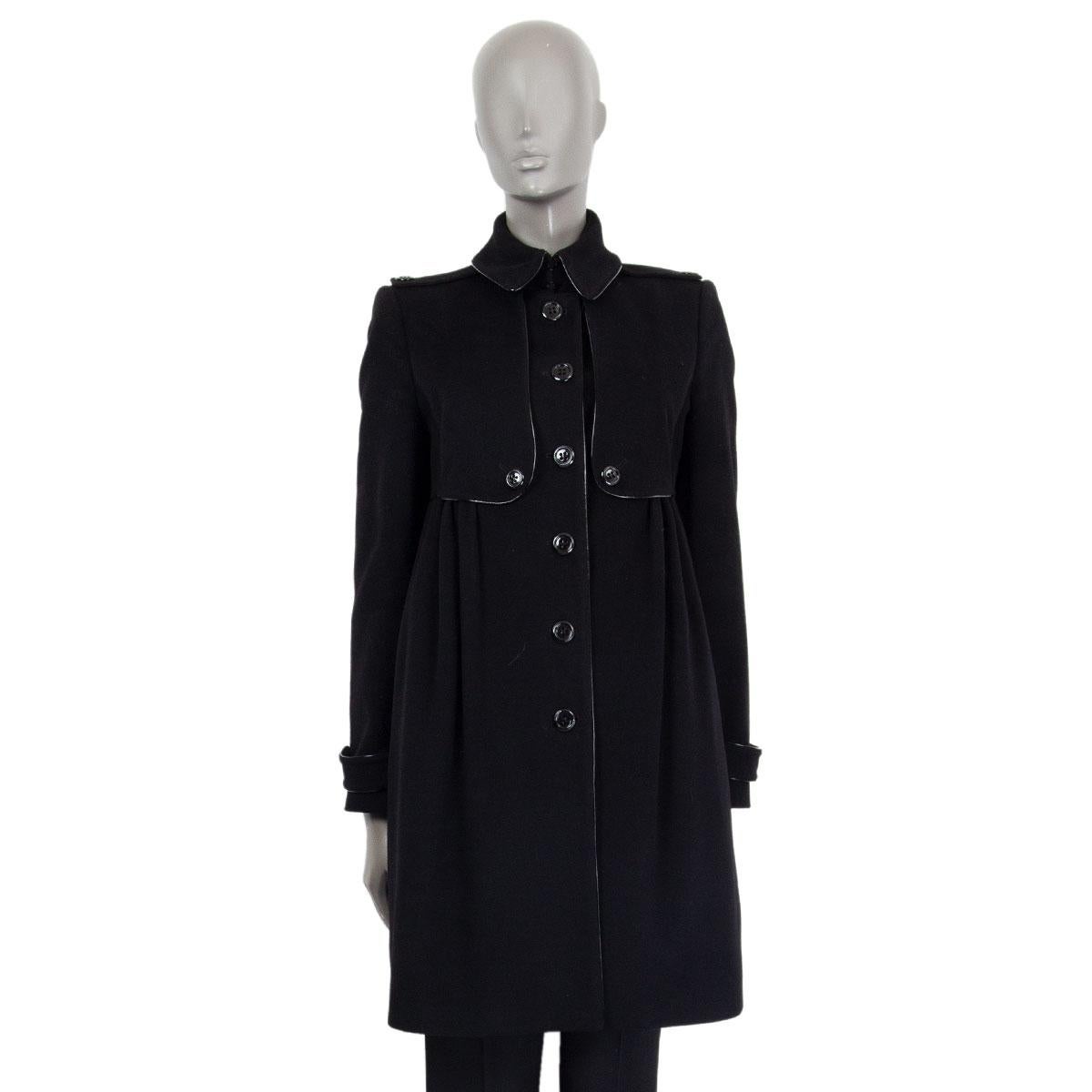 Burberry London patent trim detail coat in wool (85%) and cashmere (15%) with epaulettes on the shoulders. Opens with one hook and buttons on the front. Has slit pockets on the side. Lined in viscose (50%) and cupro (50%). Has been worn and is in