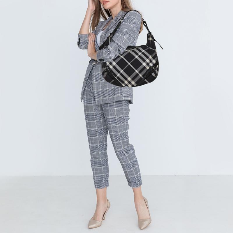 This Larkin bag by Burberry combines function and fashion. Crafted from Check canvas and leather, the bag features a spacious canvas interior to house your everyday essentials. The hobo flaunts buckle details and it is held by a single handle.

