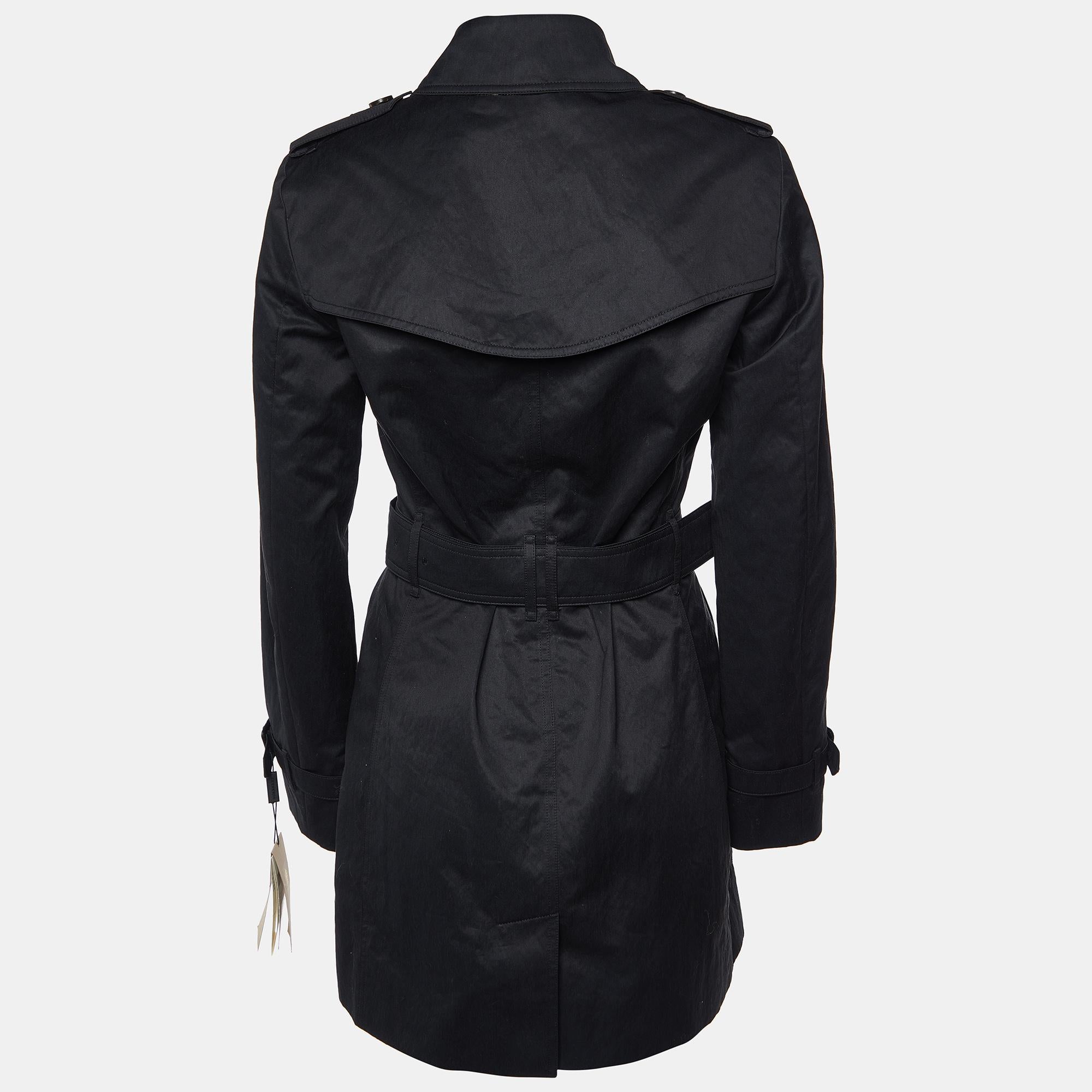 Black Burberry Harbourne trench coat with pointed collar, crew neck, dual welt pockets at front, tonal stitching throughout, Nova Check lining at interior, long sleeves, belt buckle closure at waist and button closures at center front.

Includes: