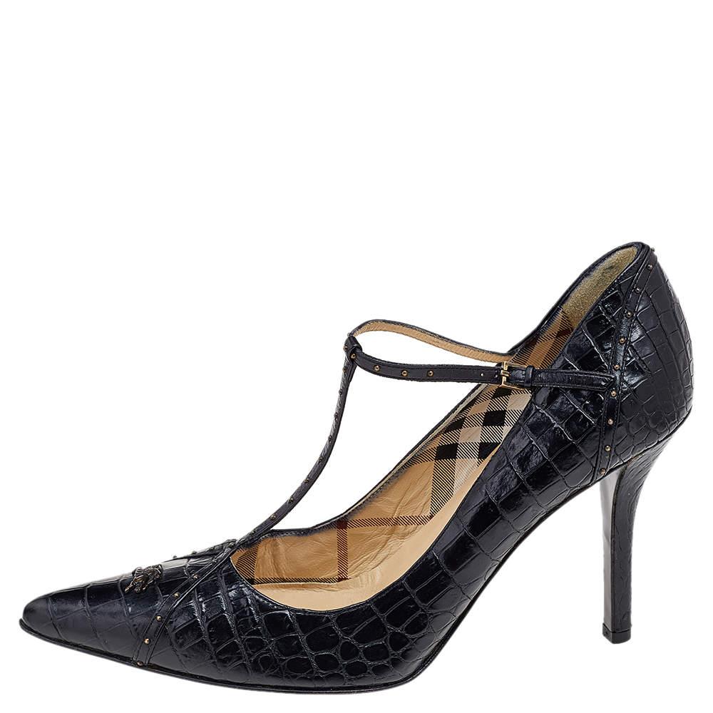 Defined by luxe cuts, unique details, durable built, and a black hue, this pair by Burberry has all the qualities of a fashionable shoe. Crafted from croc-embossed leather, they have pointed-toes, t-straps, and stiletto heels.

