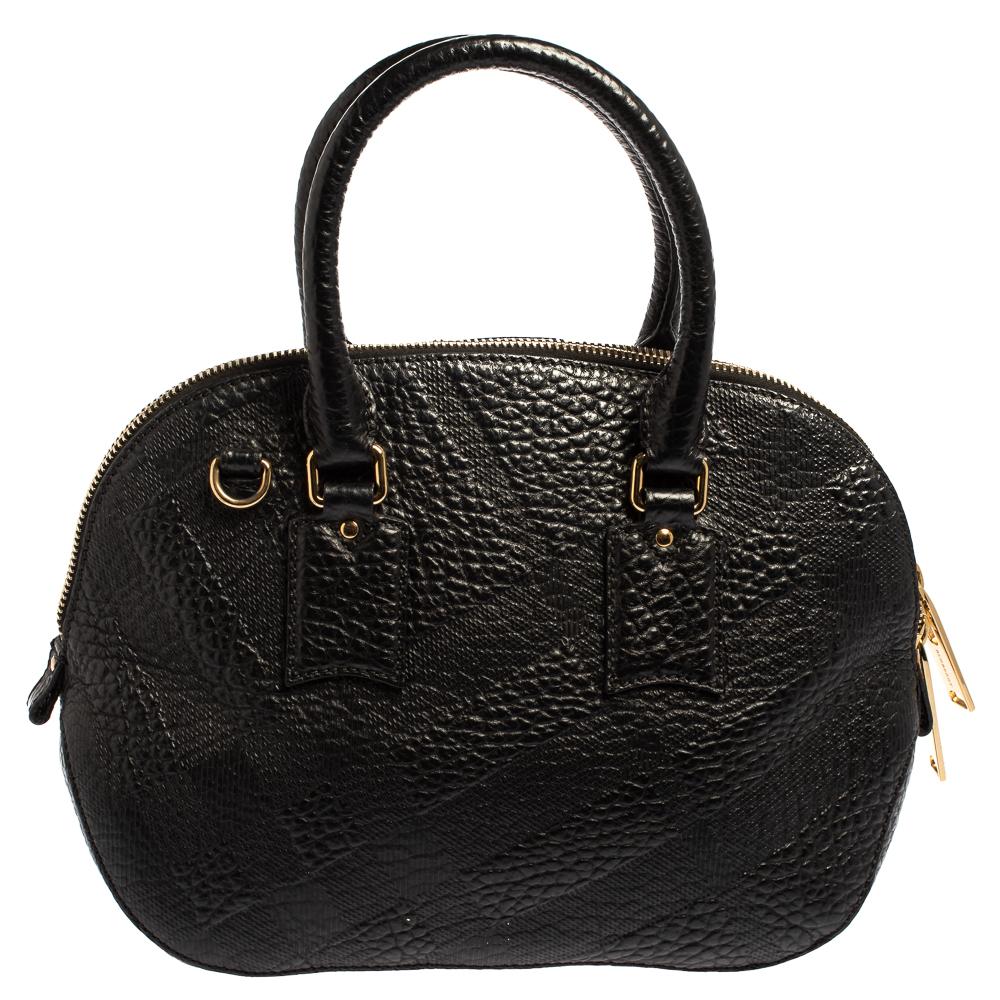 Expertly crafted and skillfully designed, this Burberry creation is a must-have in every woman's collection. It is made from embossed black leather and features two handles and a spacious fabric interior. Ideal for any day, this sophisticated bag