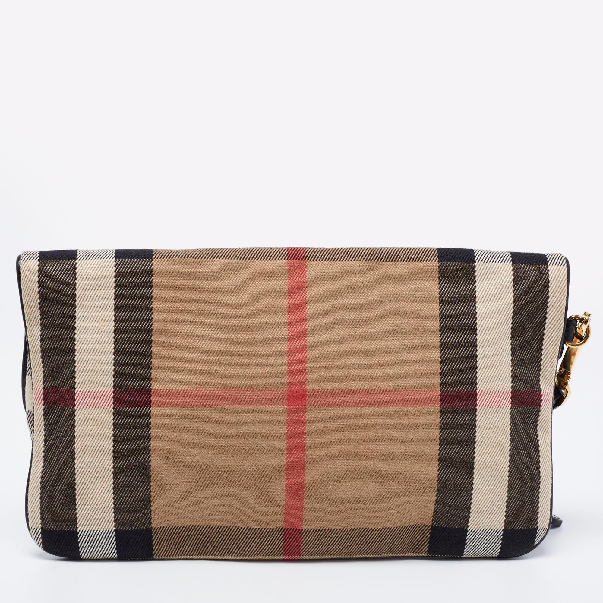 A clutch like this one from Burberry will be a handy companion. Crafted using House Check canvas and leather, this clutch is detailed with gold-tone hardware and a wristlet strap. The zip closure opens to reveal a fabric interior.

