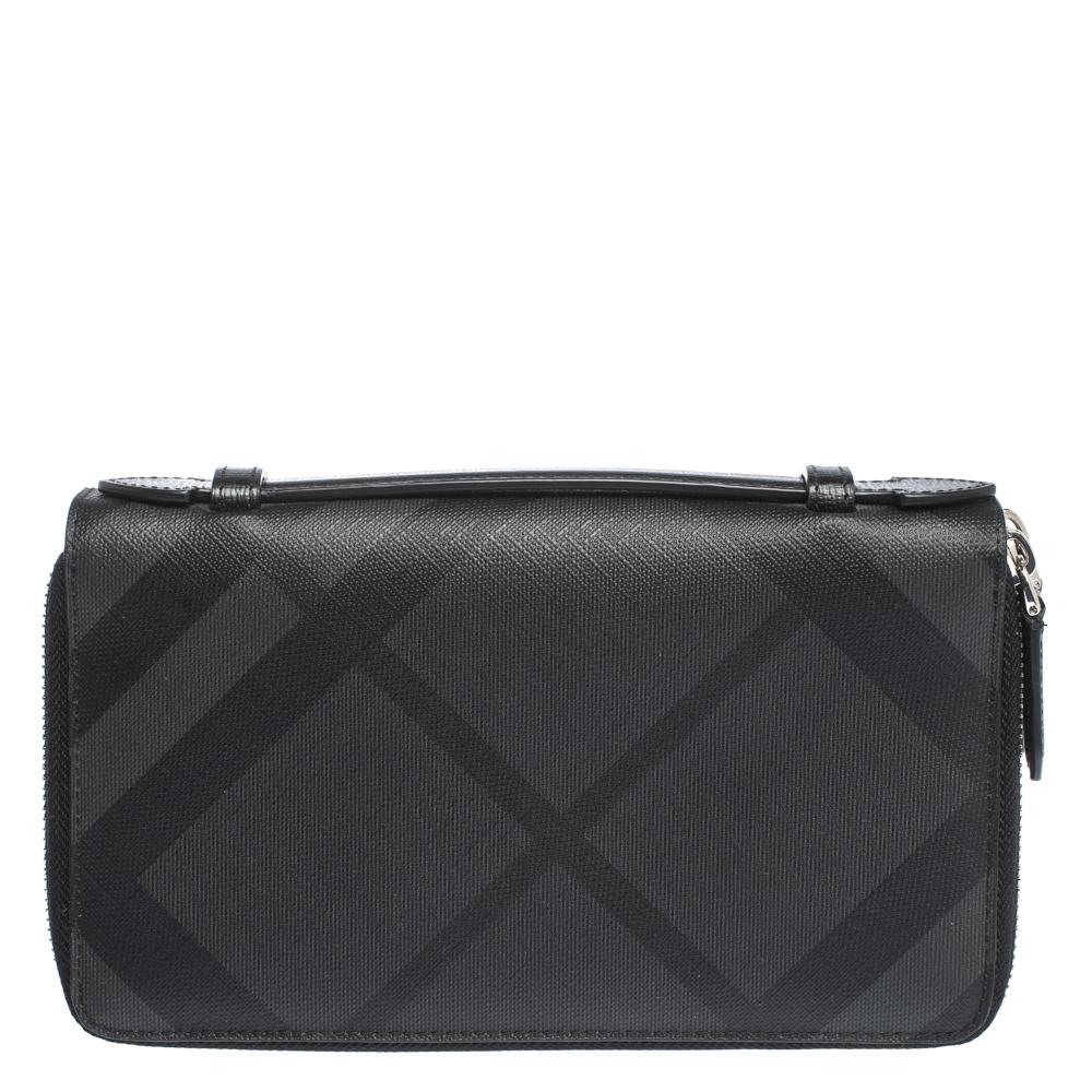 Dual zippers placed in a three-way style, a slim handle on top and plenty of compartments and slots to hold your things in an organized manner, Burberry's Reeves wallet is a creation of utility. The signature House Check canvas exterior makes it
