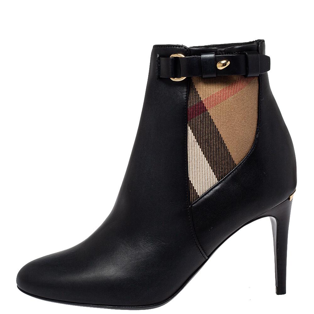 Step out in style with these Ivybridge boots from Burberry. They are made from leather and the signature Nova check canvas and designed with strap details as well as side zippers. Comfortable leather insoles and 8 cm heels complete them to