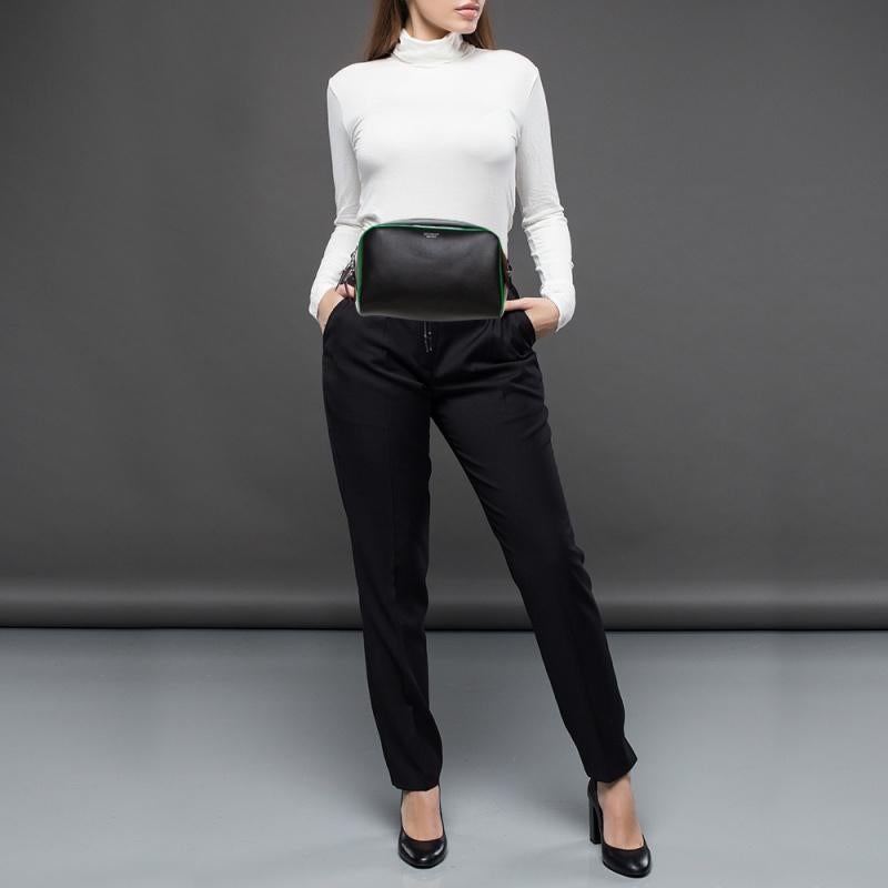 This Cube Bumbag by Burberry brings a practical and modish take. Crafted from leather, it is equipped with patent leather trims, silver-tone hardware, and an adjustable waist belt. The zip closure opens to a fabric-lined interior that houses a