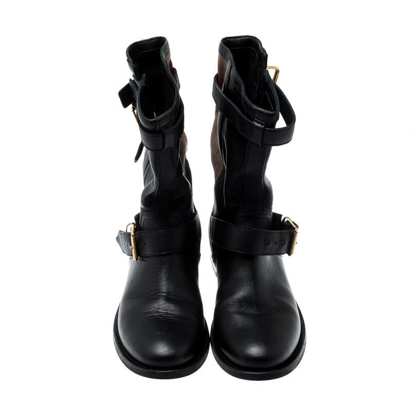 Designed in a mid-calf length, Burberry’s Grantville boots are sure to bring a comfortable twist to your outfits. Made from black leather and signature Super Nova Check canvas, this pair is enhanced with adjustable belt straps and zippers for the