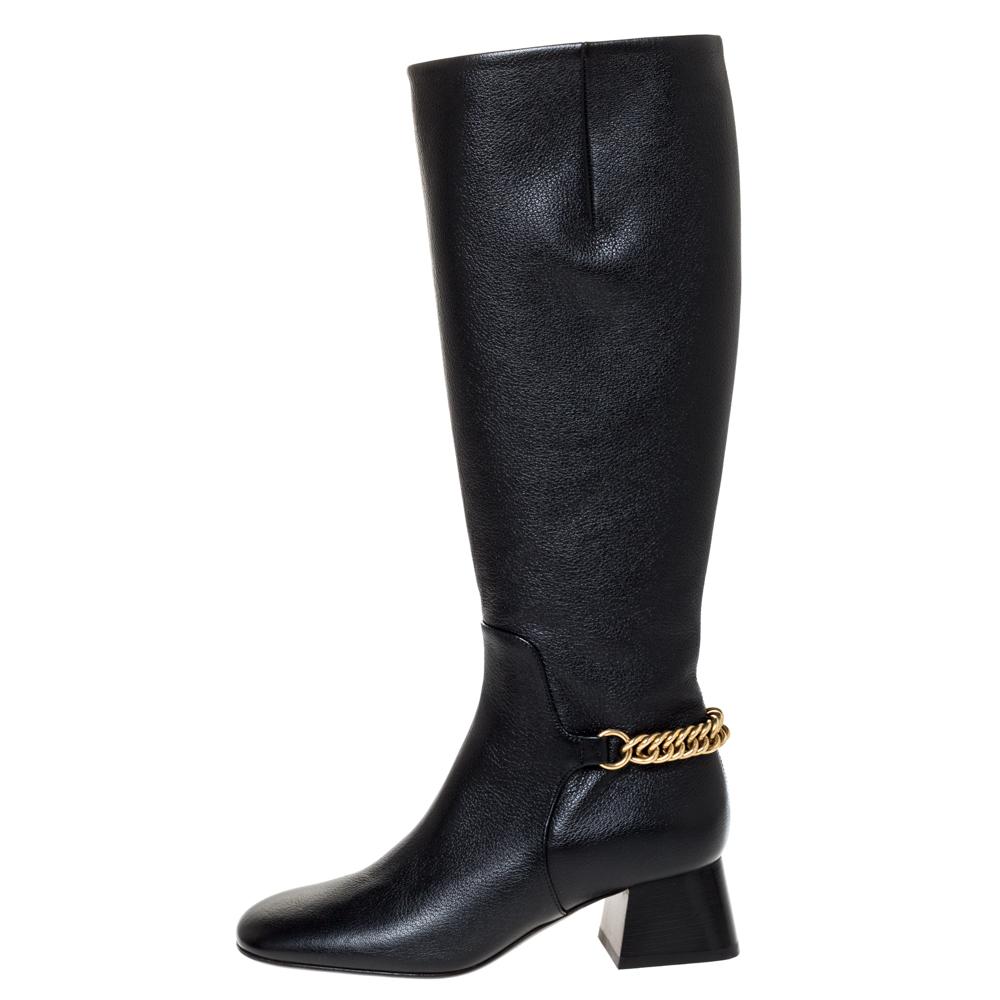 Burberry brings you this fabulous pair of knee-length boots that will give you confidence and loads of style. They've been crafted from leather in a classy black shade and styled with gold-tone chain trim on the counters, low block heels and side