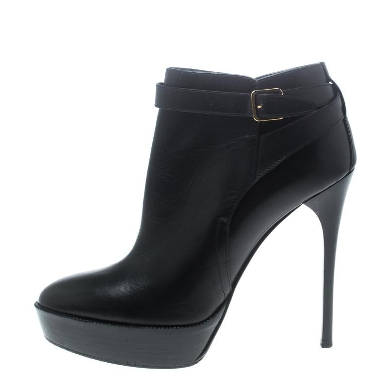 Strut your way in style and dazzle the crowds with these fabulous ankle boots from Burberry. The classic black black boots are crafted from leather and feature round toes, gold-tone buckled detailed cross ankle straps , leather lined insoles, solid