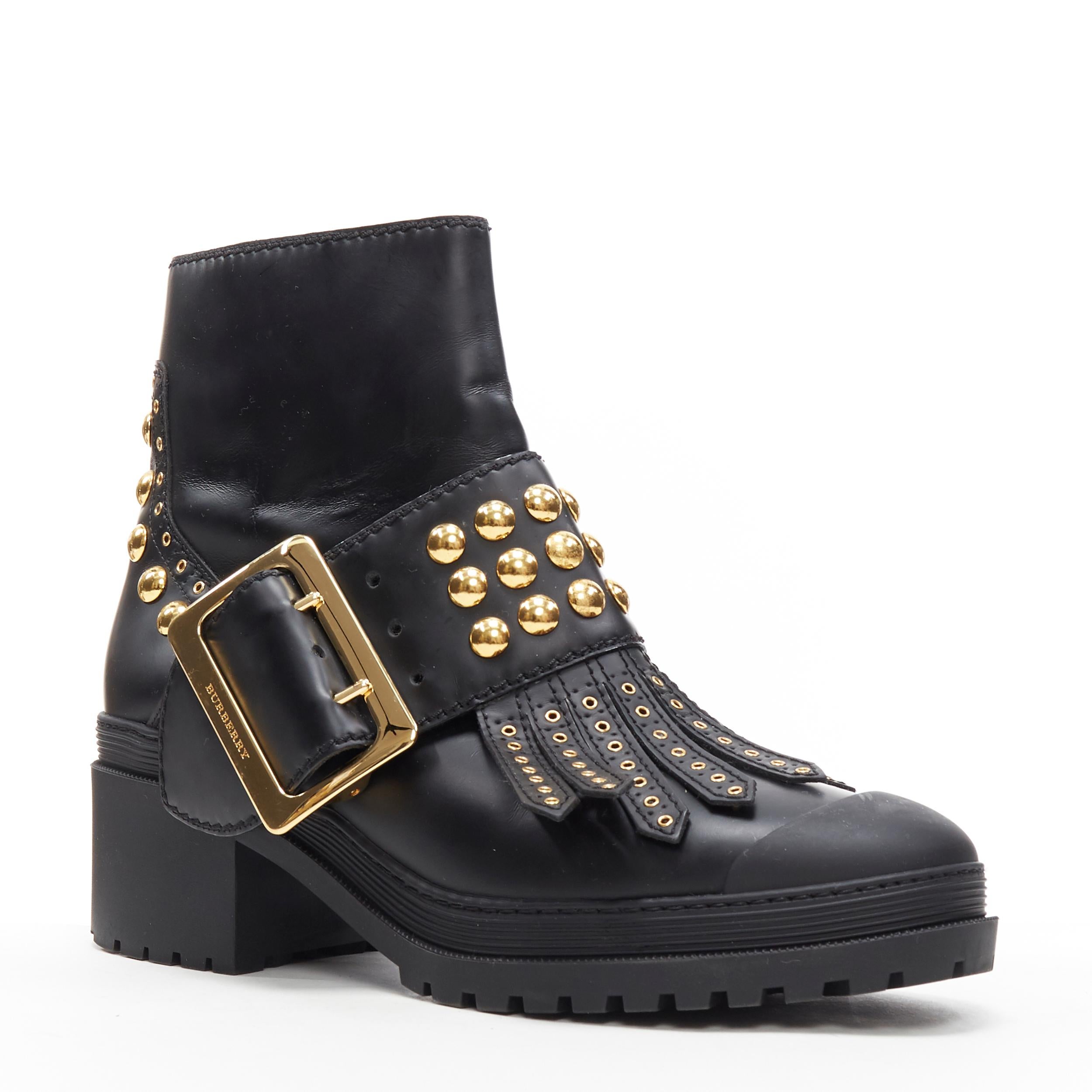 BURBERRY black leather gold studded fringe large buckle trucker ankle boot EU40
Brand: Burberry
Model Name / Style: Ankle boot
Material: Leather
Color: Black
Pattern: Solid
Closure: Zip
Extra Detail: Mid (2-2.9 in) heel height. Round Toe. Block