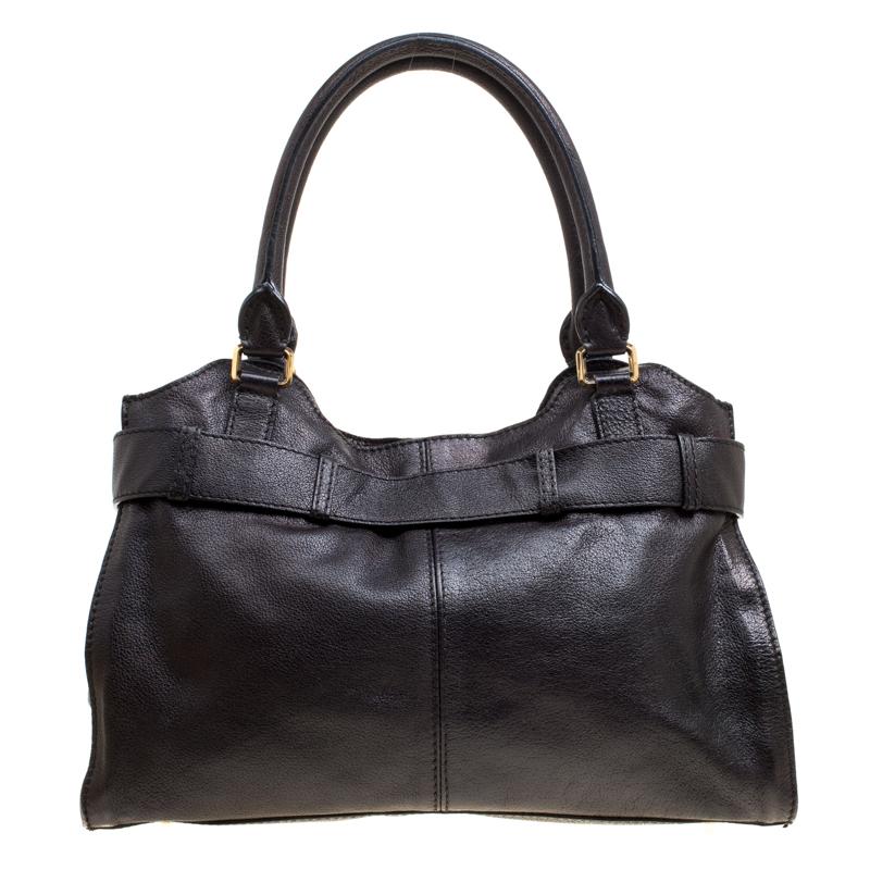 Complete a stylish look with this beautiful Burberry Lambeth tote. The black tote is crafted from leather and features a buckled band at the top with a gold-tone medallion. It flaunts dual top handle and protective metal feet. It opens to a spacious