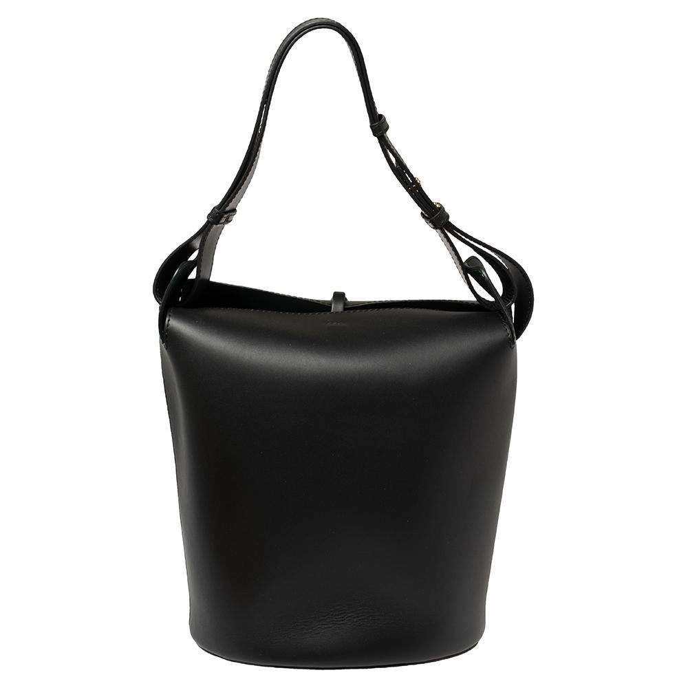 This bucket bag from Burberry is truly investment-worthy and will help you outline a stylish look! It has been crafted from leather in black and styled with a thin tuck-in flap and top handles. It opens to a leather interior that has enough space to