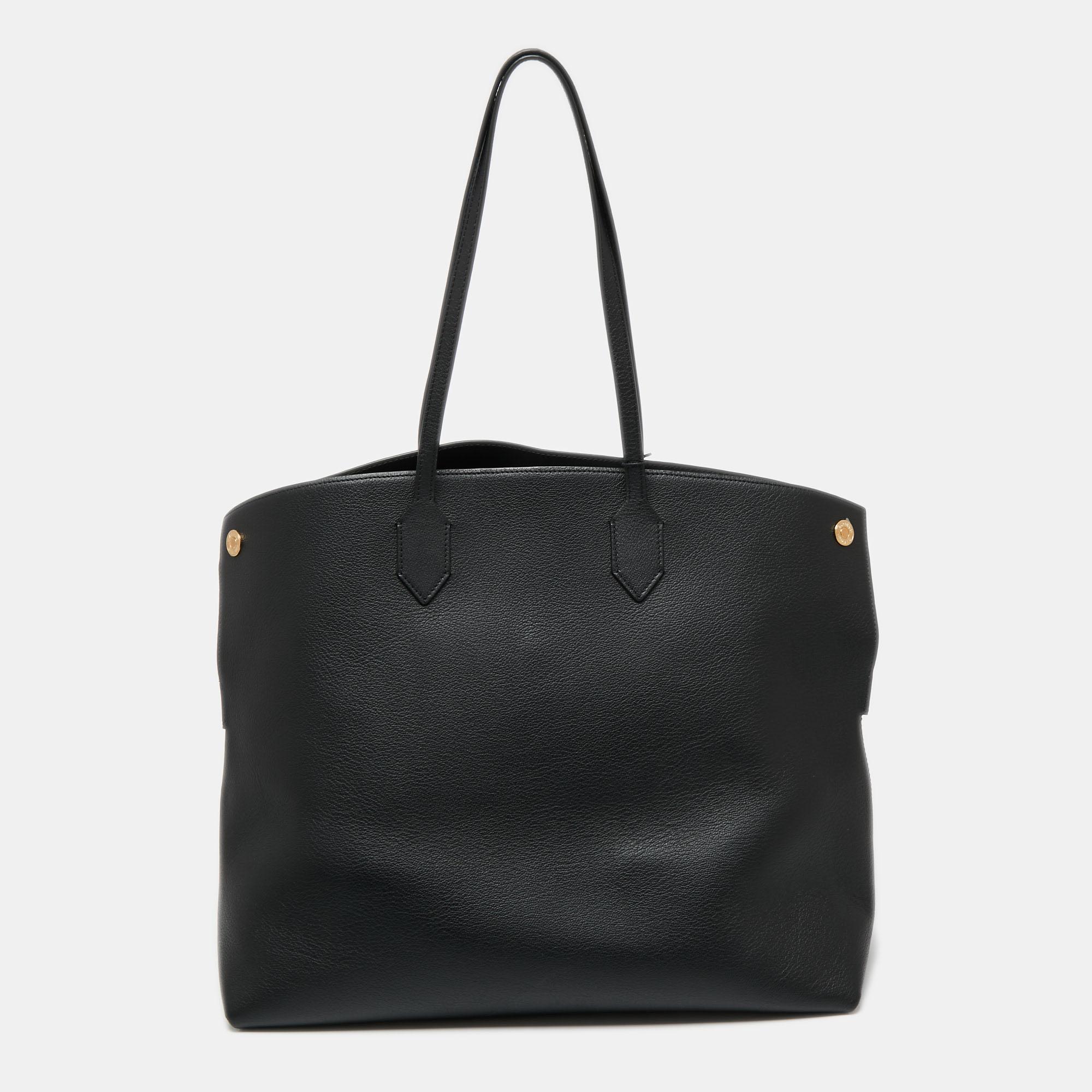With a refined construction and contemporary shape, this Burberry tote is ideal for everyday use. Its pointed edges at the top elevated the silhouette and gold-tone accents add to its charm. Crafted from leather, it flaunts dual handles at the top