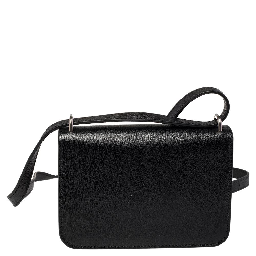 Masterfully crafted from leather, this creation in black can easily hold all your little essentials. This chic shoulder bag by Burberry features a shoulder strap, a D-ring detail, and a leather interior secured by a flap.

Includes: Original