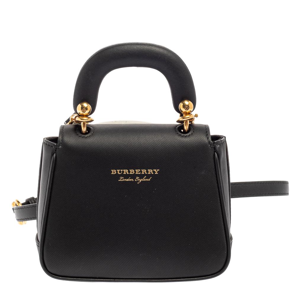 Incredibly designed, this DK88 bag from Burberry is equal parts timeless and contemporary! It has been crafted from black leather and styled with a single top handle and a gold-tone lock on the front. The flap opens to a suede interior that houses a